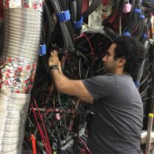 Regina graduate student Ahmed Foda cabling the LED pulser system for the GlueX Barrel Calorimeter